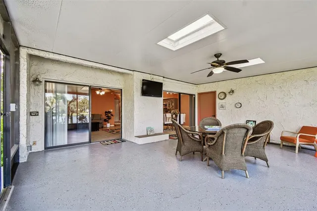 a dining room with furniture and a floor to ceiling window