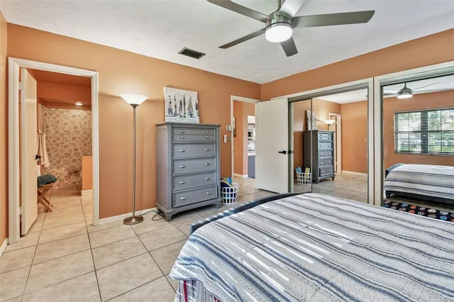 a view of a swimming pool with a patio and a yard