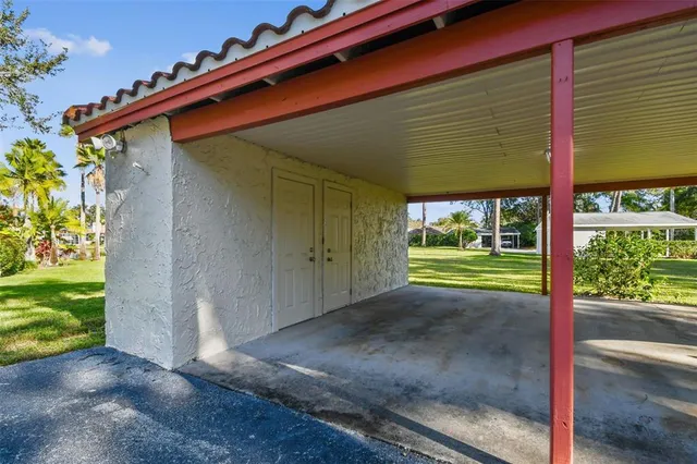 an aerial view of a house with a garden and lake view