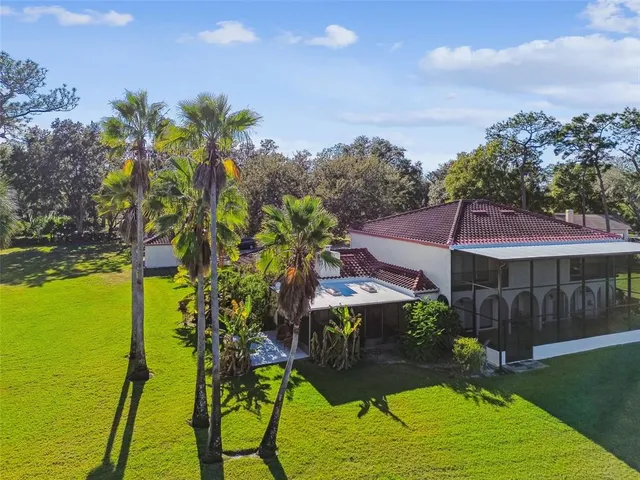 an aerial view of a house with a swimming pool yard and outdoor seating