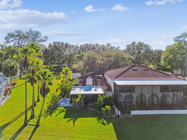 an aerial view of lake and residential houses with outdoor space