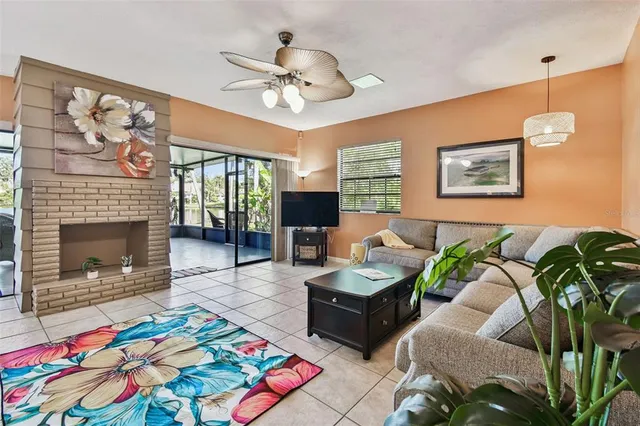 a living room with patio furniture and a fireplace