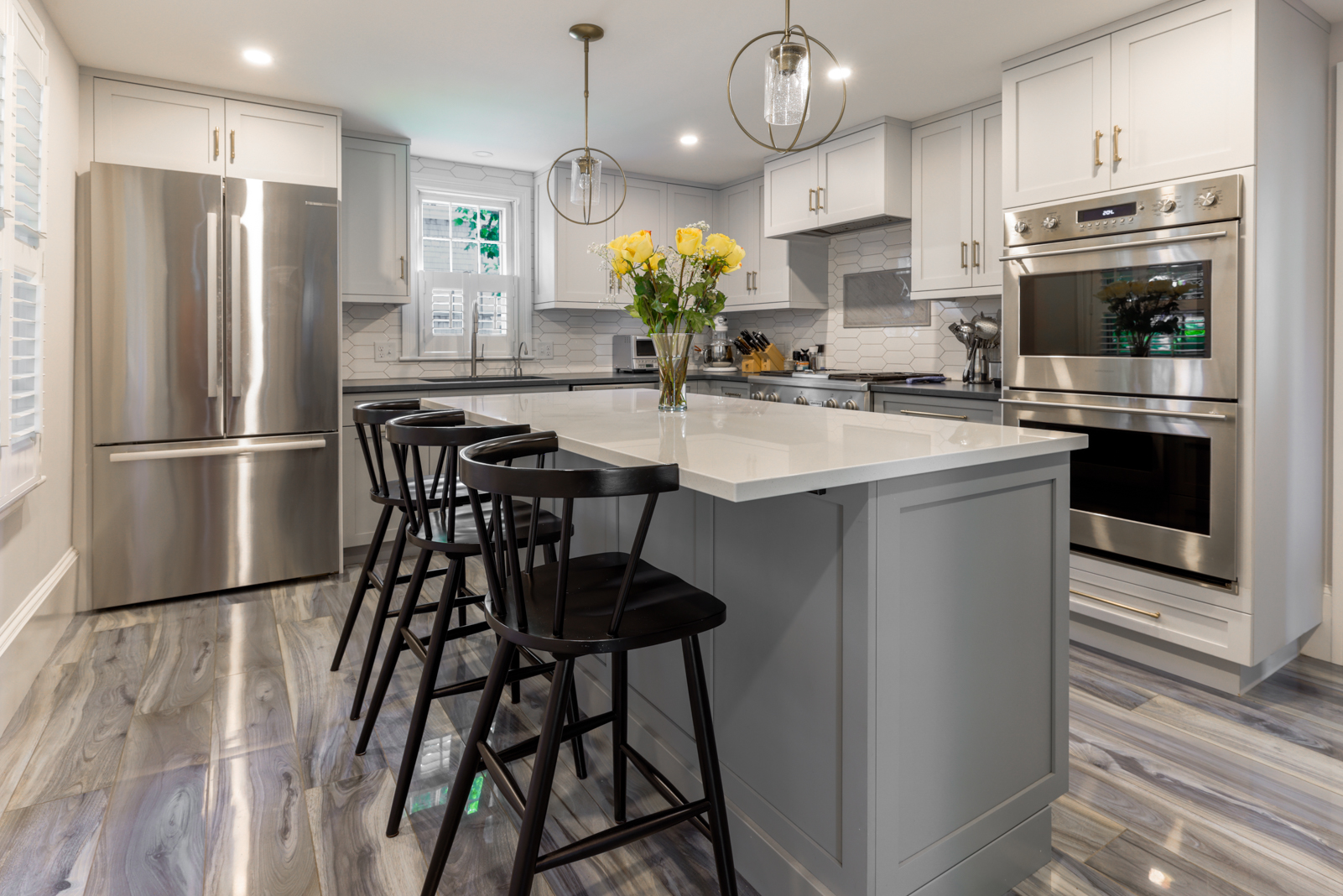 12 Hussey Street Nantucket, MA 02554 - Photo 8 of 47 a kitchen with stainless steel appliances a dining table chairs stove refrigerator and cabinets