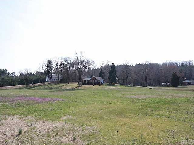 9923 North Roxboro Road Bahama, NC 27503 - Photo 2 of 12 a view of field with trees in the background