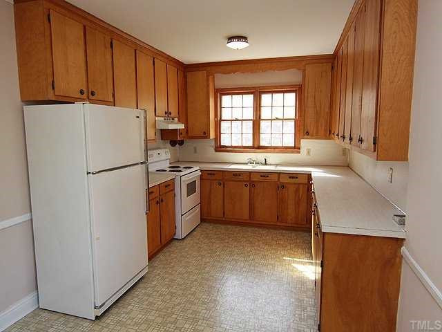9923 North Roxboro Road Bahama, NC 27503 - Photo 6 of 12 a kitchen with stainless steel appliances granite countertop a refrigerator a sink a stove and a refrigerator