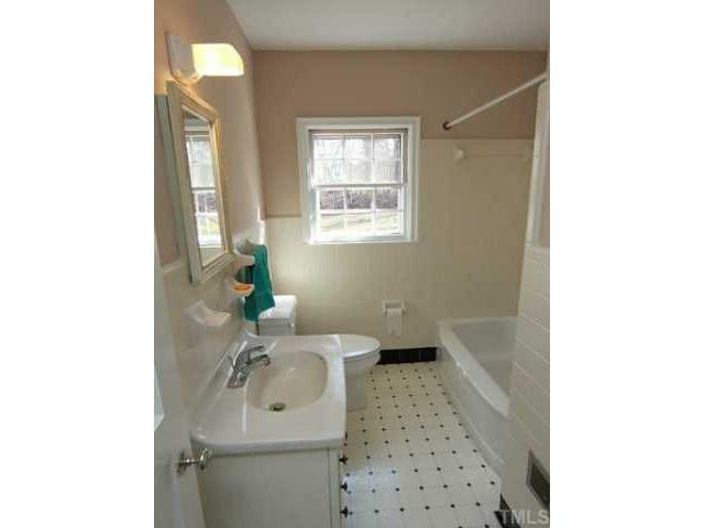 9923 North Roxboro Road Bahama, NC 27503 - Photo 9 of 12 a bathroom with a sink a toilet and tub