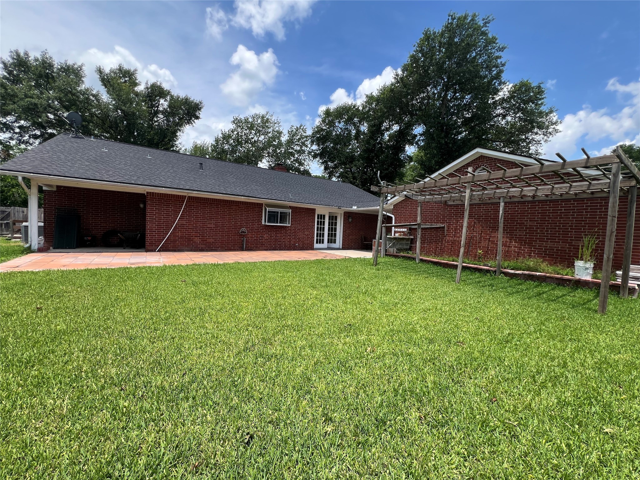 101 Willowbend Street Huntsville, TX 77320 - Photo 11 of 15 a view of a house with a yard and sitting area