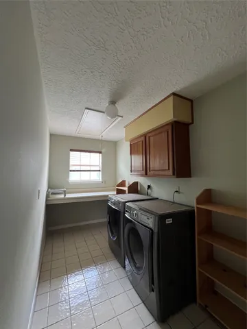 a kitchen with a sink a stove and cabinets
