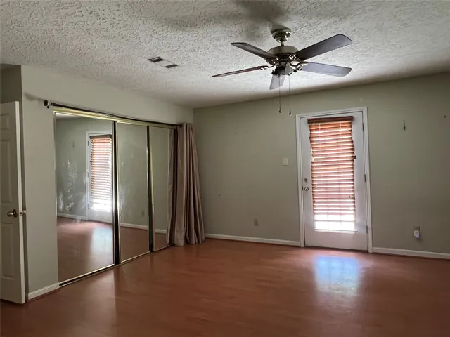 an empty room with windows and closet