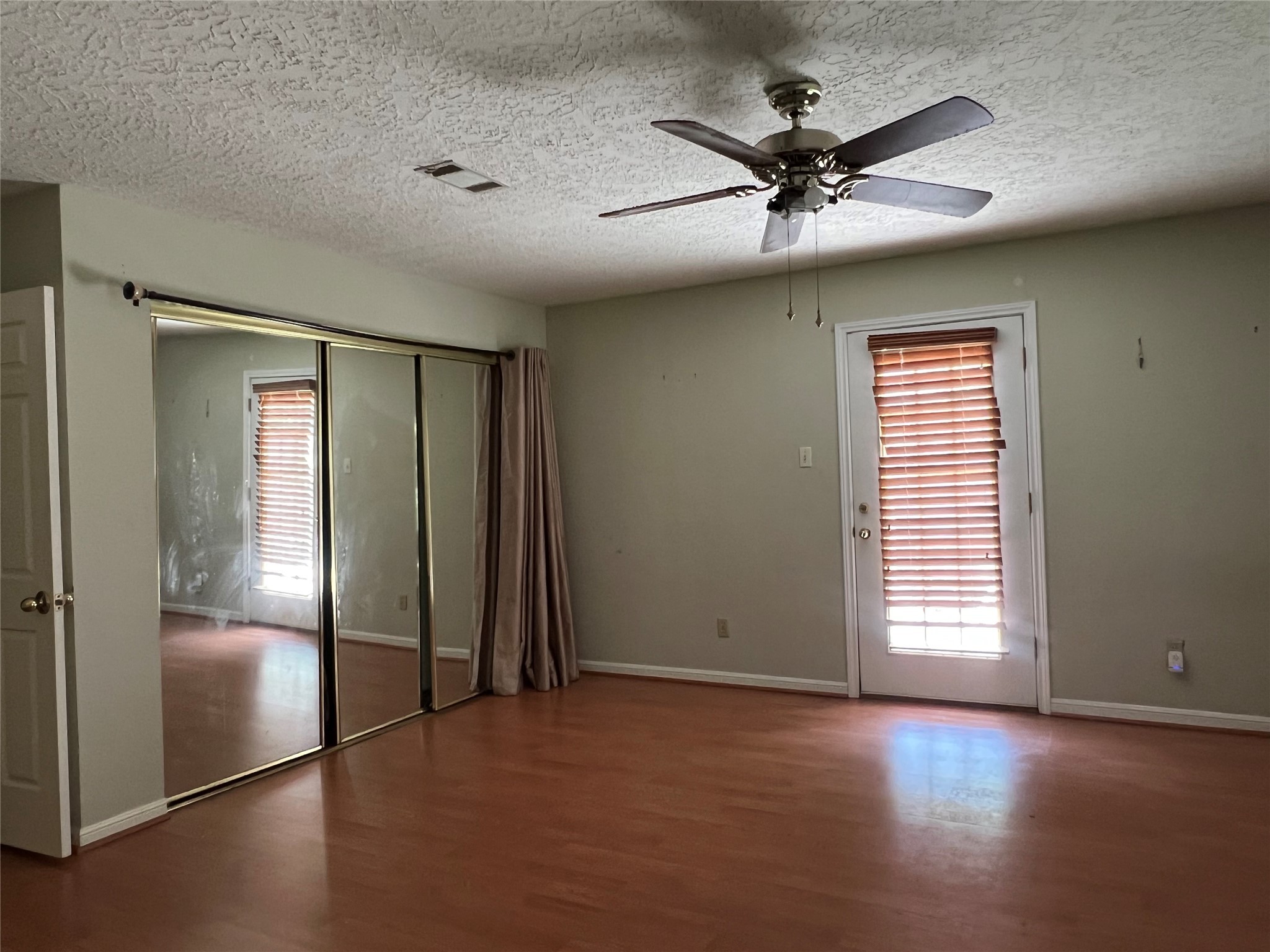 101 Willowbend Street Huntsville, TX 77320 - Photo 5 of 15 an empty room with windows and closet
