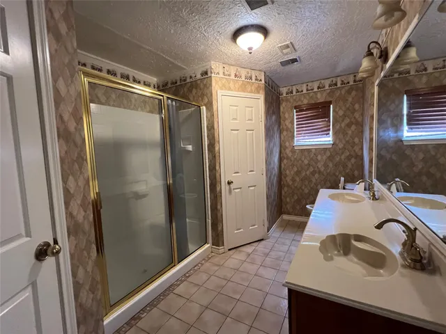 a bathroom with a sink and shower