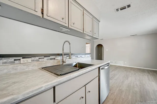 a kitchen with a sink and cabinets