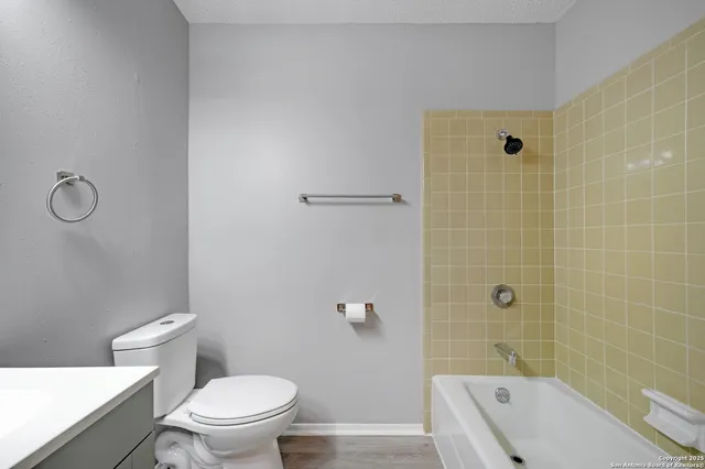 a bathroom with a toilet and shower