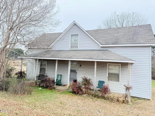 a front view of house with yard and seating space