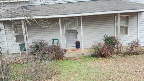 a view of a dry yard with trees