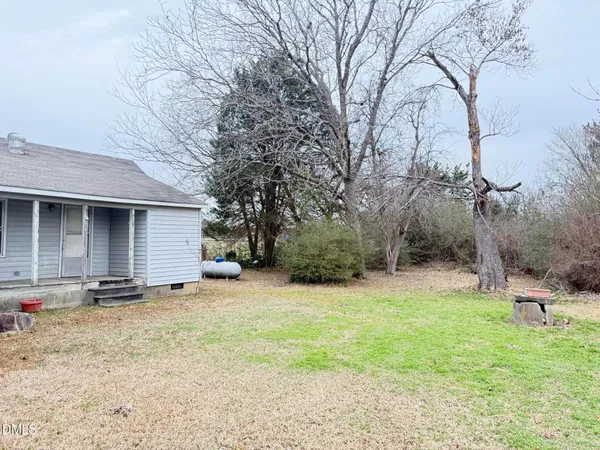 a backyard of a house with yard and garage