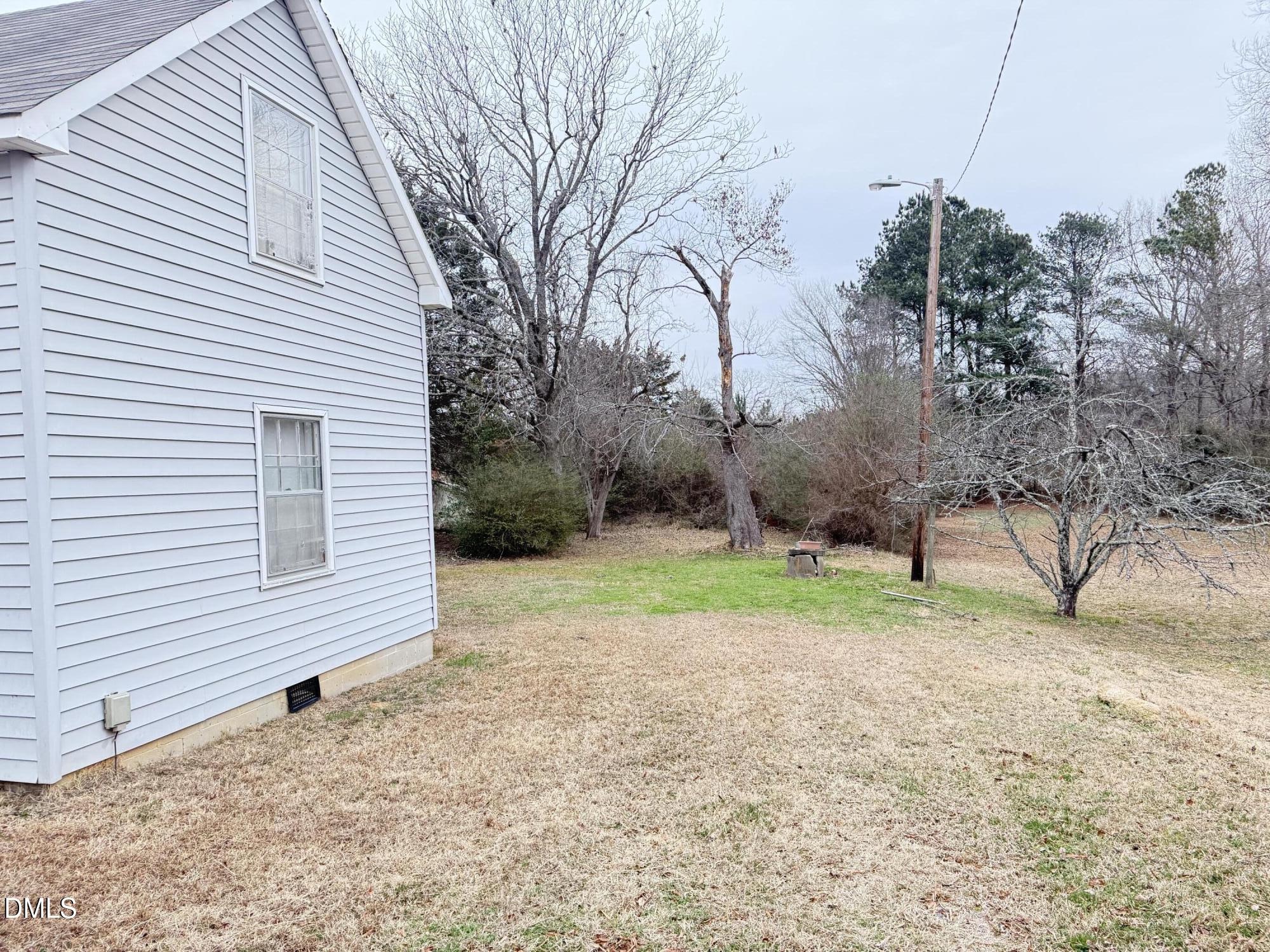 103 Howard Harris Road Franklinton, NC 27525 - Photo 9 of 12 a backyard of a house with lots of green space