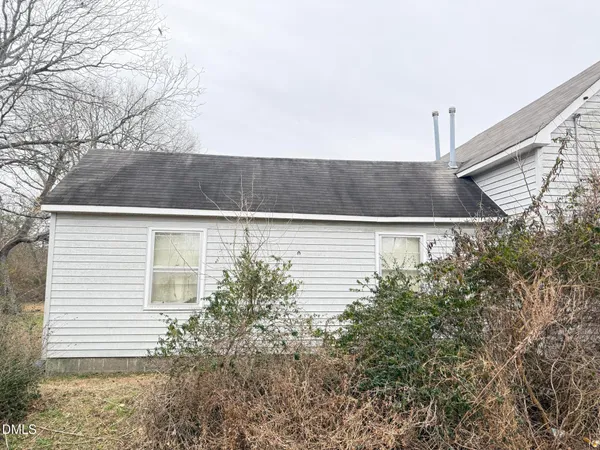 a view of a house with a yard and tree s