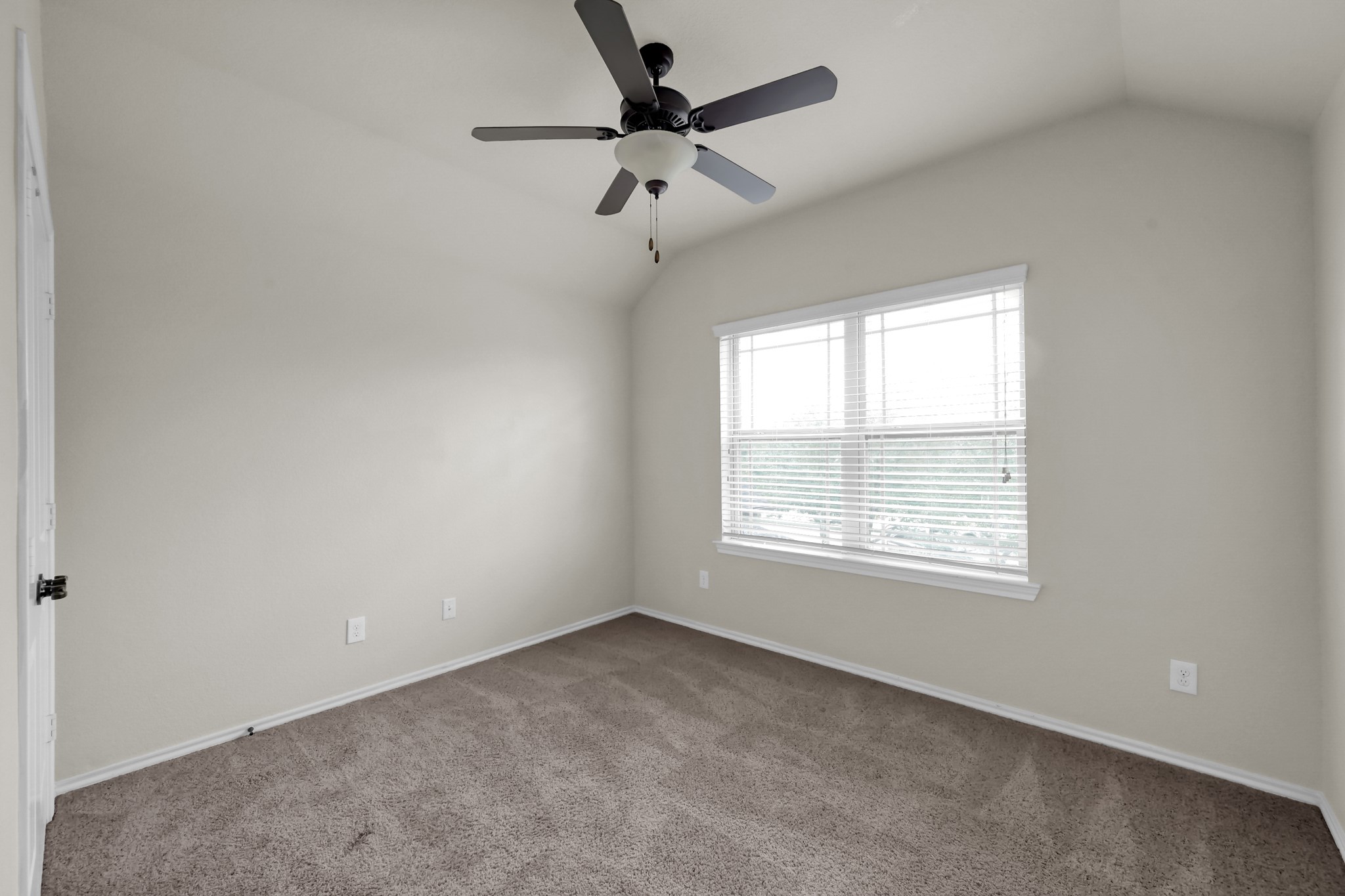 31718 Ravens Bluff Lane Spring, TX 77386 - Photo 31 of 39 Bedroom 2 has a double closet, double window, ceiling fan and carpet