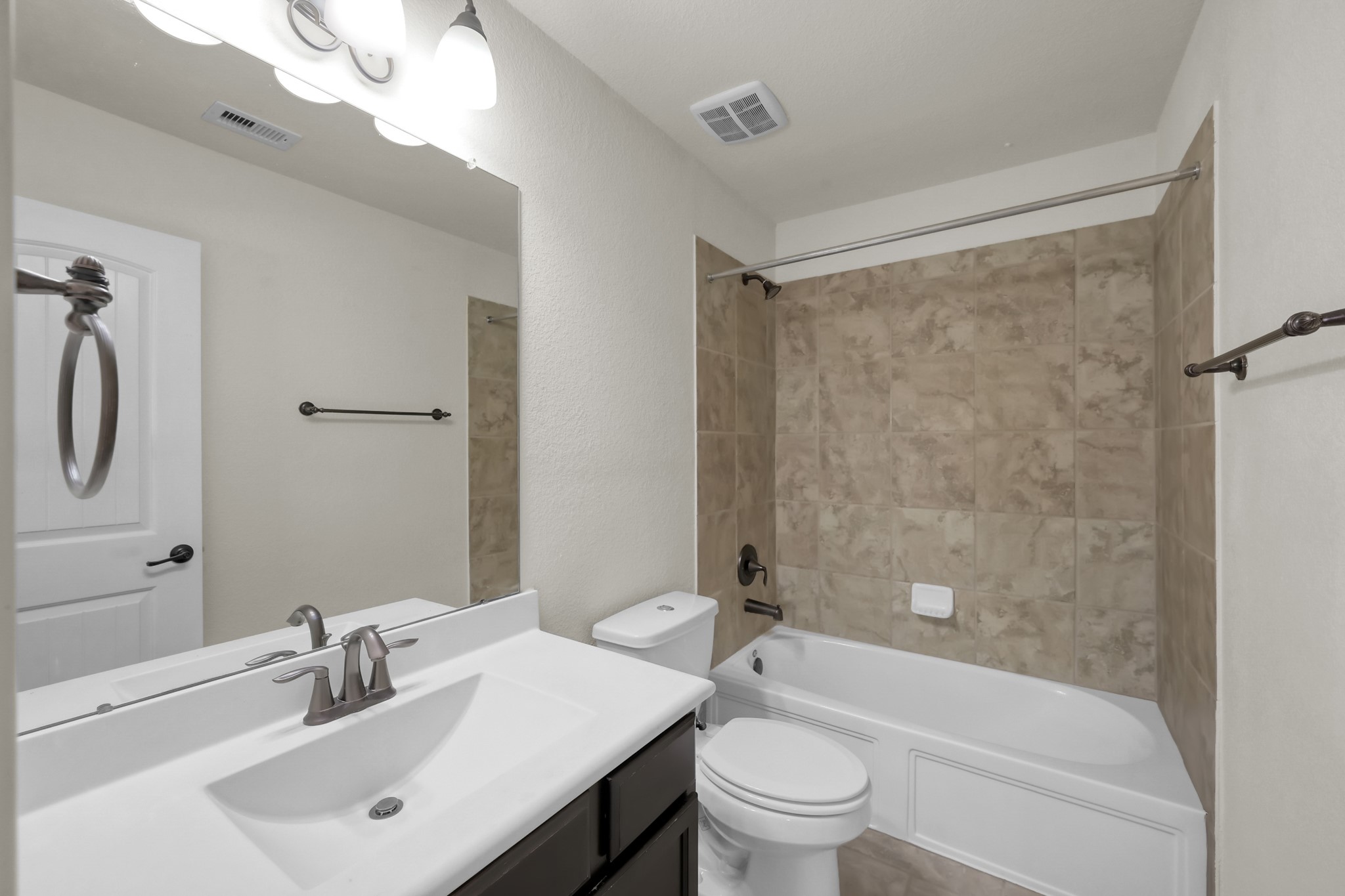 31718 Ravens Bluff Lane Spring, TX 77386 - Photo 33 of 39 Upstairs bathroom has a tub/shower combo, oil bronze fixtures, and tile flooring