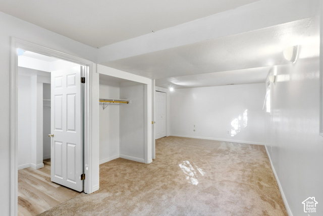 8746 Gladiator Way Sandy, UT 84094 - Photo 24 of 36 Carpeted flooring, white walls, built-in open closet, hinged door, and wall-mounted light fixtures