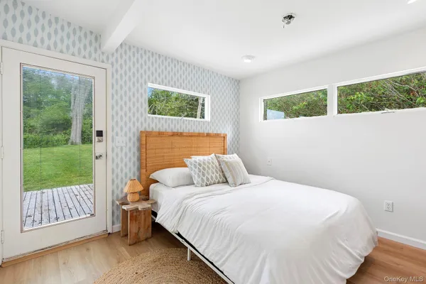 a bed sitting in a bedroom next to a window