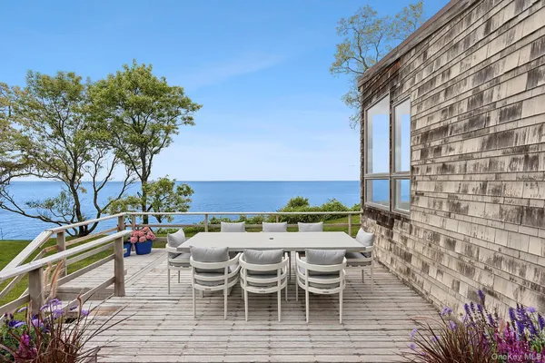 a view of a patio with couches table and chairs and potted plants