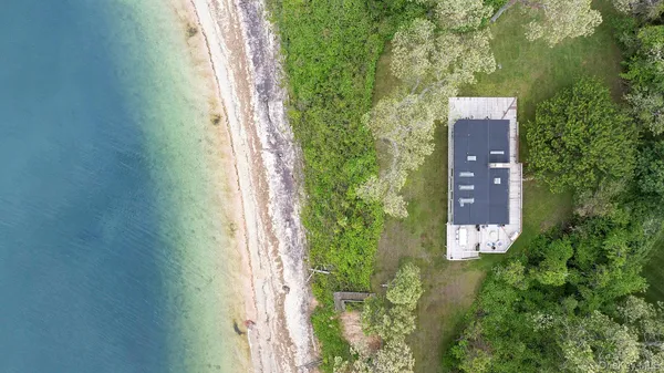 an aerial view of a house with a yard