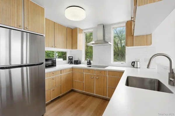 a kitchen with a sink cabinets and wooden floor