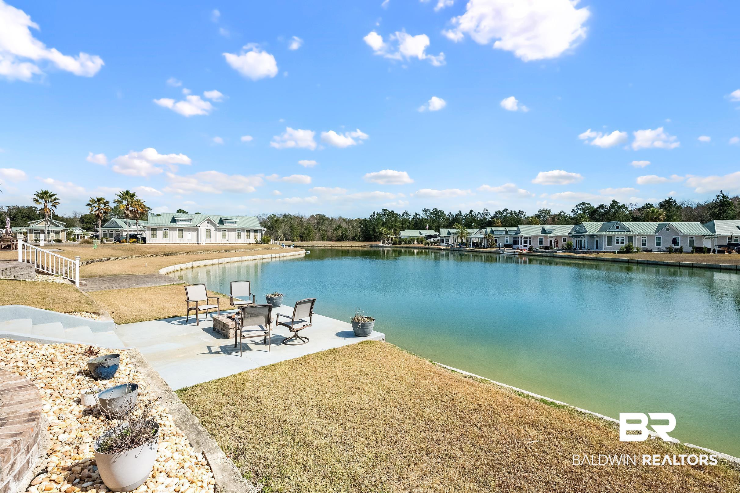 11996 Raptor Court Elberta, AL 36530 - Photo 14 of 45 Dock area with a residential view, a water view, a patio area, and a lawn