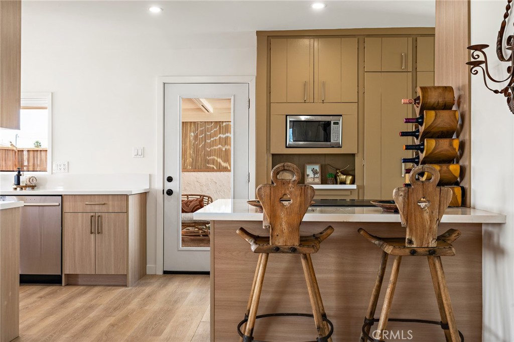 62420 Canterbury Street Joshua Tree, CA 92252 - Photo 32 of 50 a view of a kitchen with furniture and wooden floor