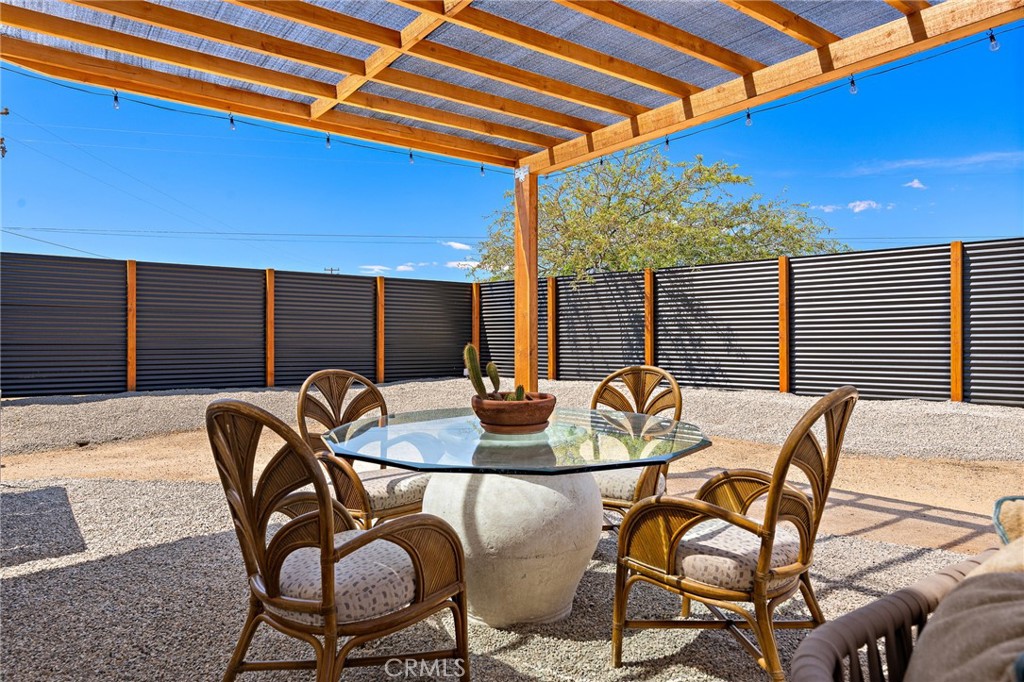 62420 Canterbury Street Joshua Tree, CA 92252 - Photo 35 of 50 a backyard of a house with table and chairs