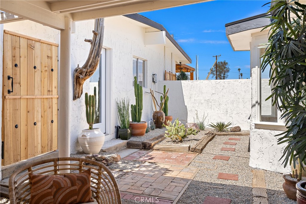 62420 Canterbury Street Joshua Tree, CA 92252 - Photo 8 of 50 a bedroom with bed and a potted plant