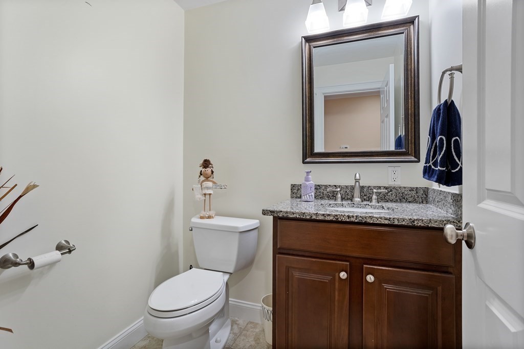 215 Rangeway Road, Unit 33 Billerica, MA 01862 - Photo 13 of 42 a bathroom with a toilet sink vanity and mirror