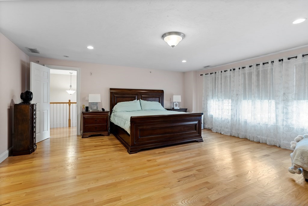 215 Rangeway Road, Unit 33 Billerica, MA 01862 - Photo 17 of 42 a bedroom with furniture and wooden floor