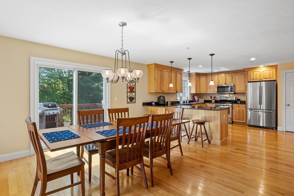 215 Rangeway Road, Unit 33 Billerica, MA 01862 - Photo 6 of 42 a view of a dining room and livingroom with furniture wooden floor a chandelier