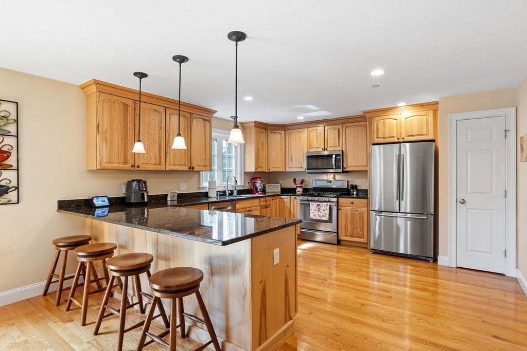 215 Rangeway Road, Unit 33 Billerica, MA 01862 - Photo 9 of 42 a kitchen with stainless steel appliances granite countertop a refrigerator a stove top oven a sink dishwasher and white cabinets with wooden floor