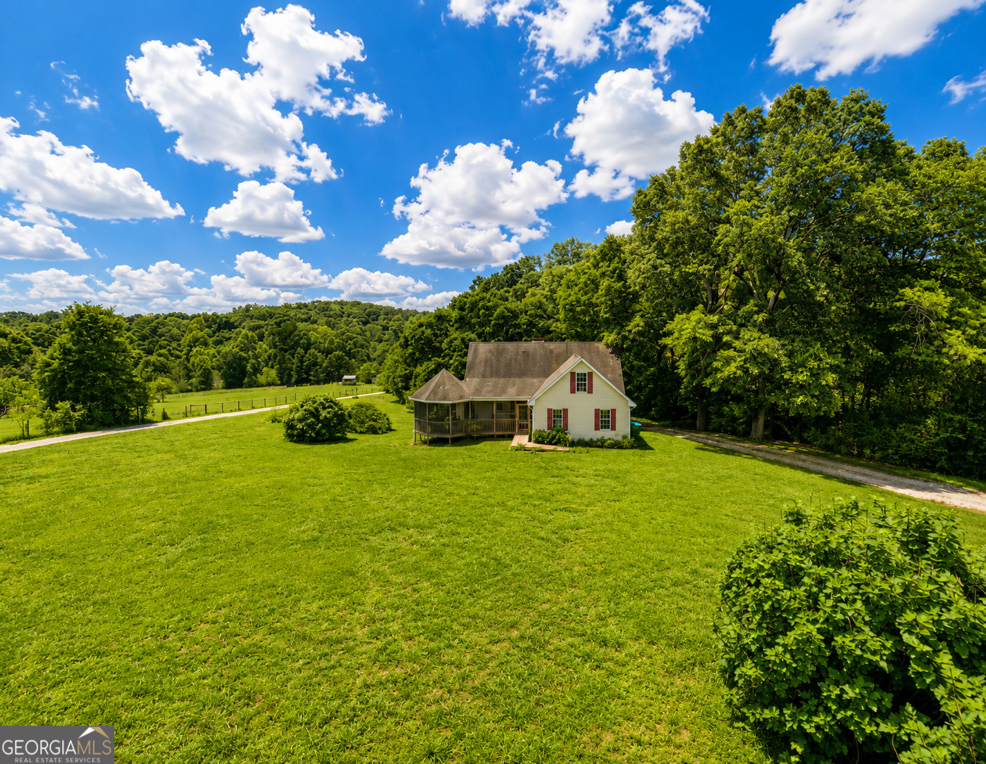 2433 Bear Creek Road Statham, GA 30666 - Photo 5 of 58 a front view of a house with garden