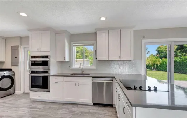 a kitchen with a sink stove and cabinets