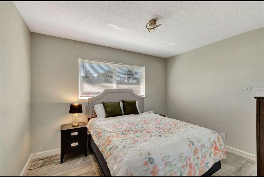 125 Southeast 6th Avenue Boynton Beach, FL 33435 - Photo 17 of 27 a bedroom with a bed and a night stand