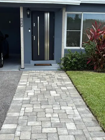 a view of a brick house with a yard