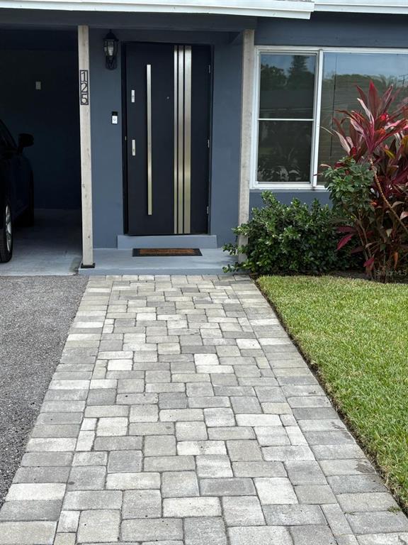 125 Southeast 6th Avenue Boynton Beach, FL 33435 - Photo 3 of 27 a view of a brick house with a yard