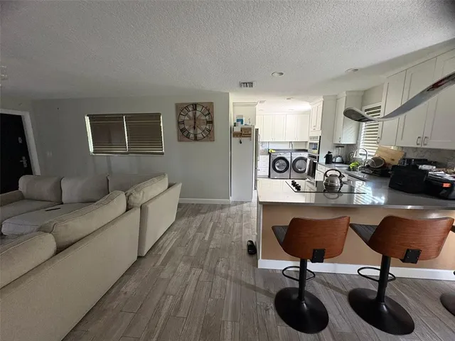 a living room with furniture a couch and a potted plant