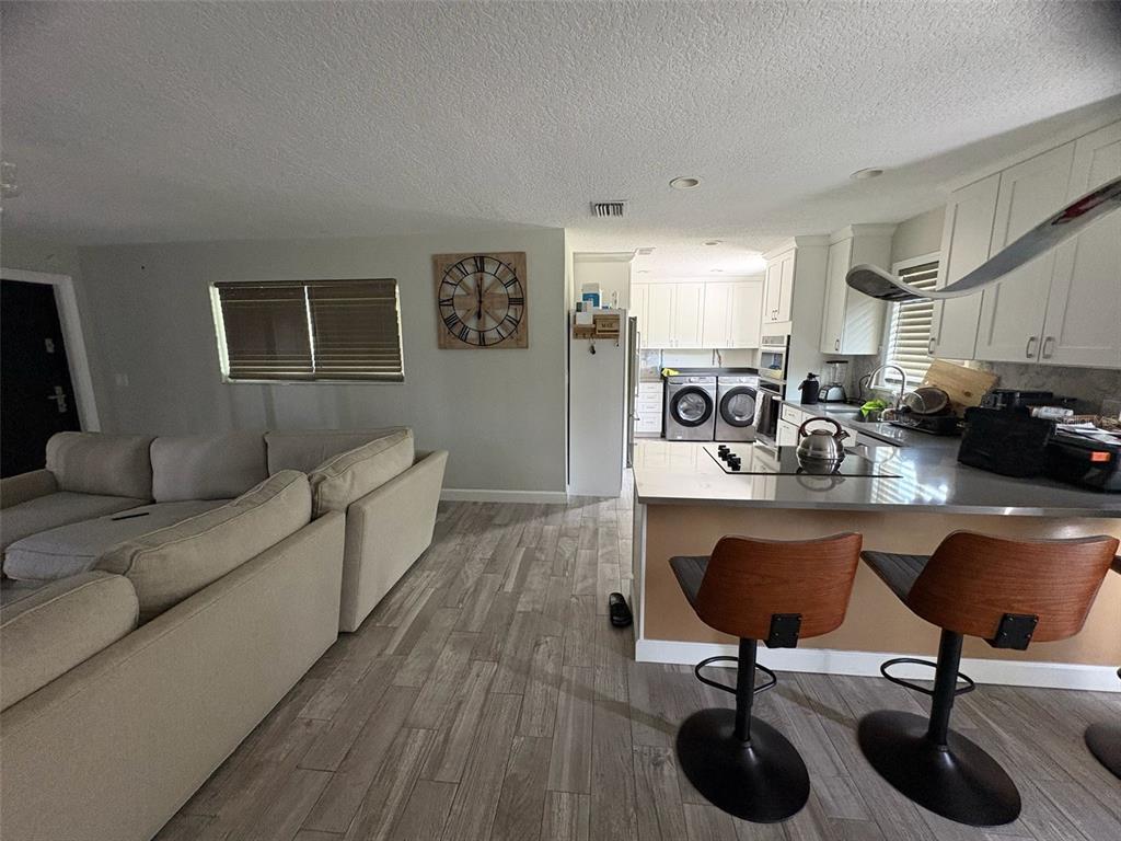 125 Southeast 6th Avenue Boynton Beach, FL 33435 - Photo 8 of 27 a living room with furniture a couch and a potted plant