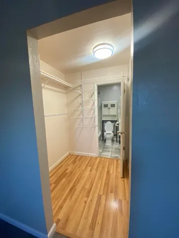 a bedroom with a bed and a mirror