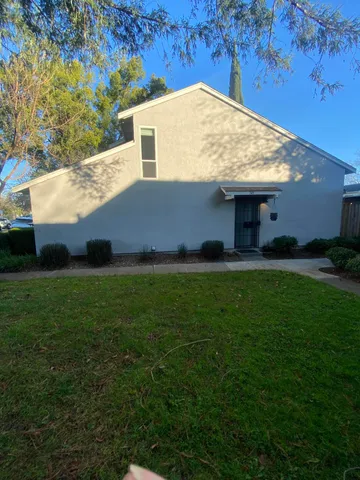 a view of house with backyard