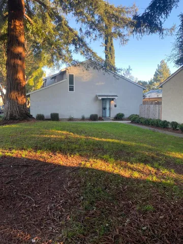 a view of a big yard with a house in the background