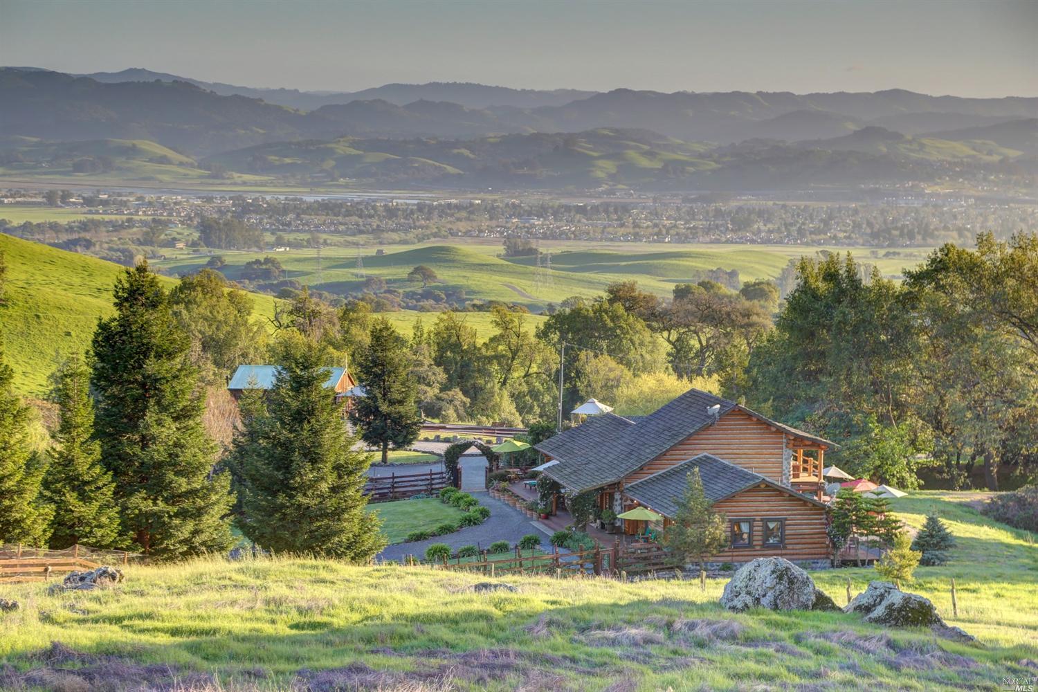a view of house with yard and ocean view