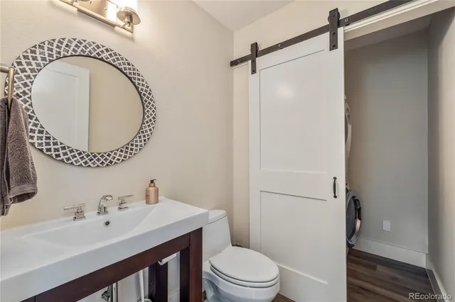 a bathroom with a sink a toilet and a mirror