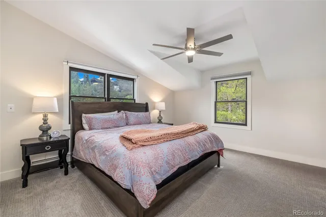 a bedroom with a bed and a ceiling fan
